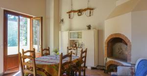 a dining room with a table and a fireplace at Seme di Luna in Canneto +53 photos