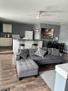 a living room with a couch and a kitchen at Blue door loft upper apartment in Thorold