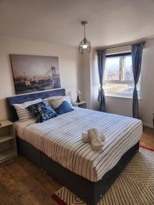 a bedroom with a large bed with a large window at City View Salford in Manchester