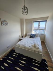 a bedroom with a bed and a window at City View Salford in Manchester