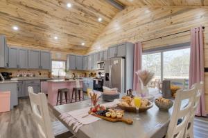 a kitchen with a table with a bowl of fruit on it at Pink Pines AvantStay Luxury Aesthetic Dream Home Indoor Pool Hot Tub in Pigeon Forge