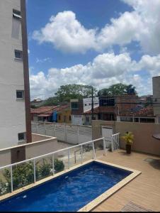 a balcony with a swimming pool on top of a building at Não está disponível para locação in Ilhéus