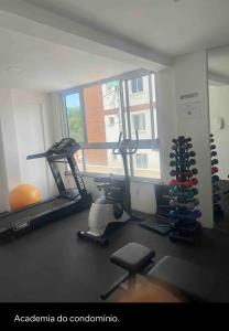 a gym with two tread machines and a window at Não está disponível para locação in Ilhéus