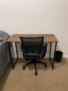 a desk with a chair in front of a bed at Comfy Guest House by Columbus Circle in New York