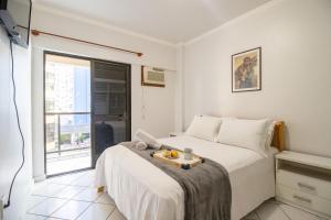 a bedroom with a bed with a tray of fruit on it at BOR41 - Quadra Mar, 4 Dorm, 2 Garagens, Churrasq. in Balneário Camboriú