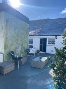 a patio with two chairs and a table at Specious City Victorian House in Plymouth