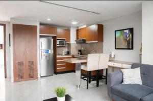 a kitchen and living room with a blue couch at Gran suite en Samborondonķo in SamborondÃ³n