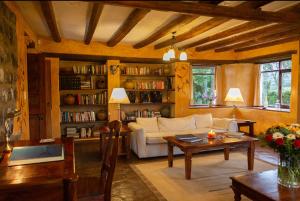 a living room with a couch and a table at Hacienda San Agustin de Callo in Lasso