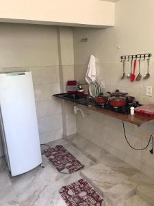 une cuisine avec un comptoir avec des casseroles et des poêles dans l'établissement Residencial Estrela Guia 1, à Cabo Frio