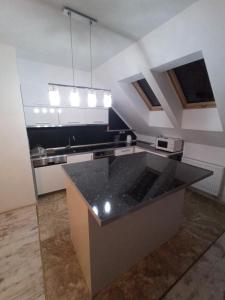 a kitchen with a black counter top in a room at Apartament Warmiński - Old Town in Biskupiec