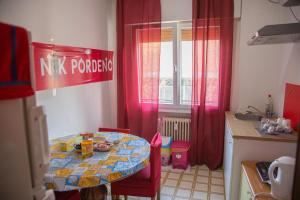 a small kitchen with a table and a table and chairs at Holiday Guesthouse in Marghera