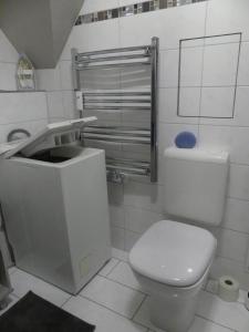 ein weißes Bad mit einem WC und einem Waschbecken in der Unterkunft Wohlfühloase by Rent Rooms Rietz in Stein bei Nürnberg