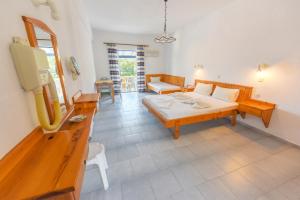 a living room with a couch and a table at Pavlis Studios Kampos in Marathokampos