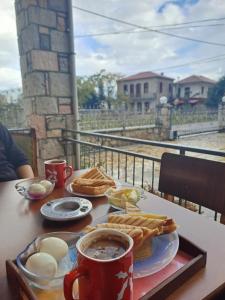 a table with a tray of breakfast food and a cup of coffee at Kontolati's Mountain House in Graviá