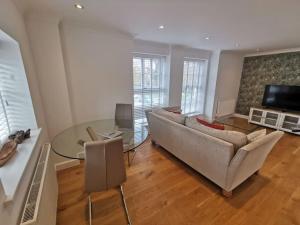 a living room with a couch and a glass table at No.12 - The Meadow in Banbury