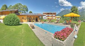 a home with a swimming pool and a house at Schneck Apartments in Schönau am Königssee