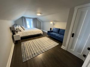 a bedroom with a bed and a blue couch at Spacious Retreat Near Convention Centers home in Des Plaines