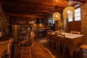 a kitchen with a dining room table and chairs at Casa da Vila - Manteigas in Manteigas