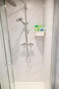 a shower with a glass door in a bathroom at London City Self Check-in Luxury Rooms in London