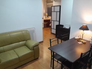 a living room with a couch and a table at Habitación SF in Madrid