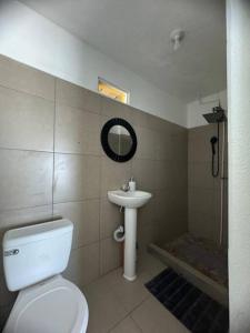 a bathroom with a white toilet and a sink at Casa Equipada con Vista Panorámica #1 in San Pedro La Laguna