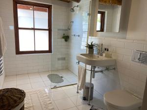 a white bathroom with a sink and a toilet at Peredraai in Prince Albert