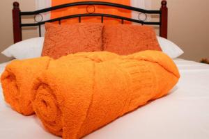 an orange blanket laying on top of a bed at San Juan Loft in Santiago