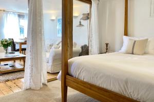 a bedroom with a bed and a mirror at Althea House with parking in Padstow