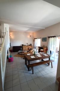 a living room with a table and a couch at La maison de Béa in Le Rouget
