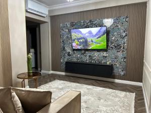 a living room with a tv on a wall at GT apartments in Chisinau in Chişinău