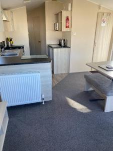 a kitchen with a counter and a table at Family Caravan, Seton sands, Haven holiday village in Port Seton