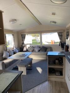 an rv living room with a couch and a table at Family Caravan, Seton sands, Haven holiday village in Port Seton