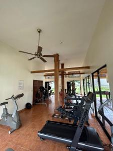 a gym with treadmills and exercise bikes in a room at Liberia vacational condo in Liberia
