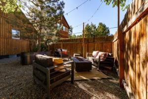 a patio with chairs and a couch and a fence at Whitewater Apartment in Boise
