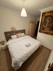 a bedroom with a large bed with a white comforter at Cosy & magnifique appartement Marrakech in Marrakech