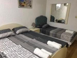 a hotel room with two beds and a mirror at Meri in Gevgelija