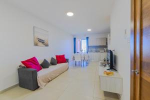 a living room with a couch and a kitchen at Spacious Brand New Apartment 3 Bdr 2Bth Bugibba HC12 in St. Paul's Bay