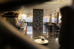 a restaurant with a table with a spoon on a counter at Aliante Malang in Malang