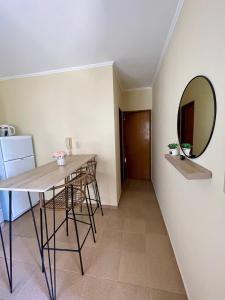 a dining room with a table and a mirror at Chill Home IV in Posadas