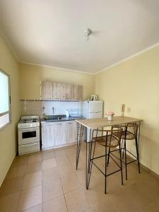 a kitchen with a table and chairs in a room at Chill Home IV in Posadas +4 photos