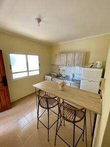 a kitchen with a wooden table and two chairs at Chill Home IV in Posadas