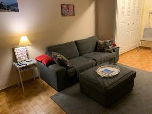 a living room with a couch and a table at Cap d Antibes, Salis beach , 2 bedrooms , free parking in Antibes