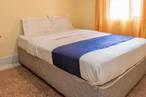 a large bed in a room with a window at City Space Hotel in Nairobi