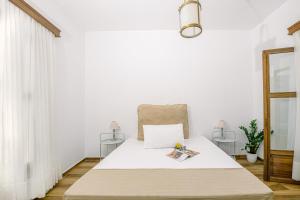 a white bedroom with a bed with a chair at Kissamos Bay Hotel in Kissamos +43 photos