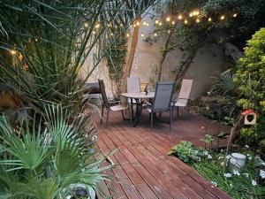 a patio with a table and chairs and plants at Villa Kata in Rab