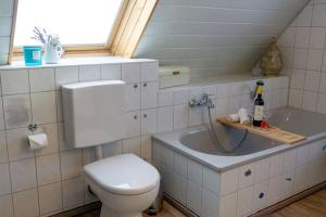 a bathroom with a toilet and a sink and a window at Apartment Christina in Weingarten