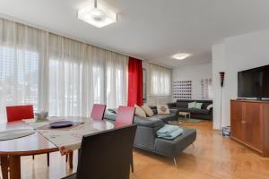 a living room with a table and a couch at Vila Ida in Zagreb