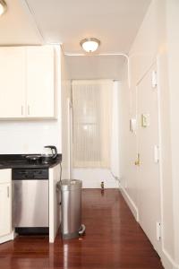 a kitchen with a trash can in the middle of a room at Private Loft in Hells Kitchen near Times Square in New York