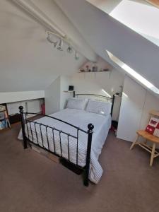 a bedroom with a bed in an attic at Spacious 3bed semi/Gamesroom/Drive/10mins to City in Wrexham