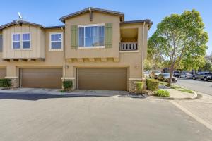 a house with two garage doors in a street at Oxnard Vacation Rental about 2 Mi to Beach! in Oxnard